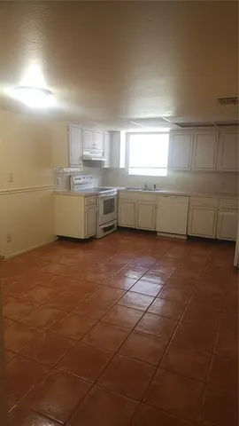 a kitchen with a sink a counter space and cabinets