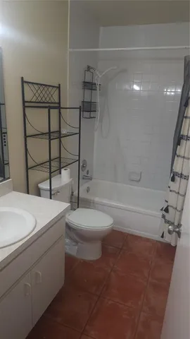 a bathroom with a toilet a sink and a shower