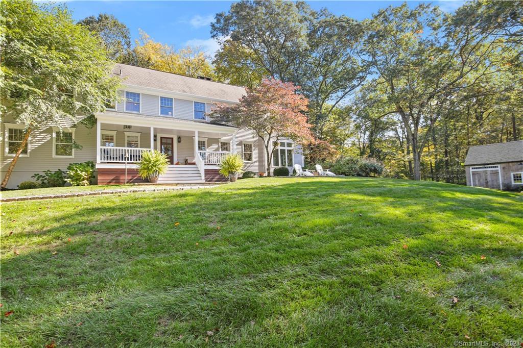 31 Shadow Lane Wilton, CT 06897 - Photo 1 of 1 a view of a house with a big yard and large trees