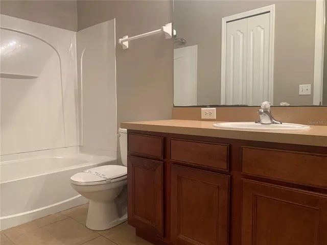 a bathroom with a sink a toilet and tub