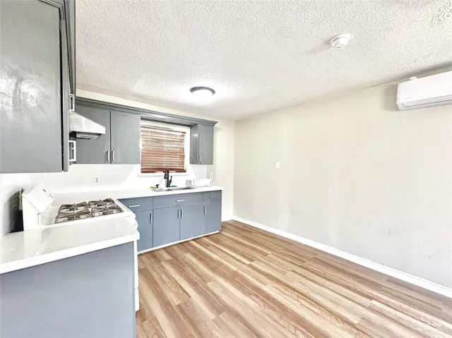 a spacious bathroom with a sink a mirror and a bathtub