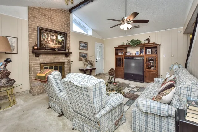 a living room with furniture and a fireplace