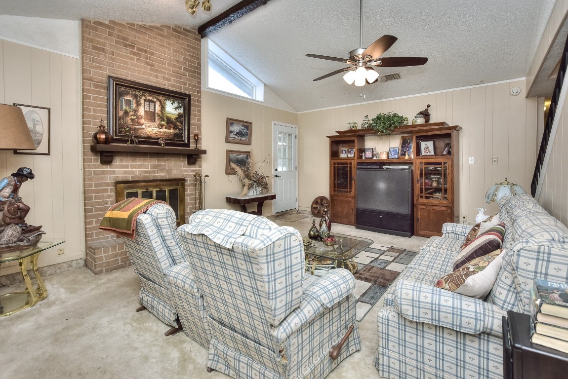 118 Oak Ridge Circle Georgetown, TX 78628 - Photo 11 of 40 a living room with furniture and a fireplace