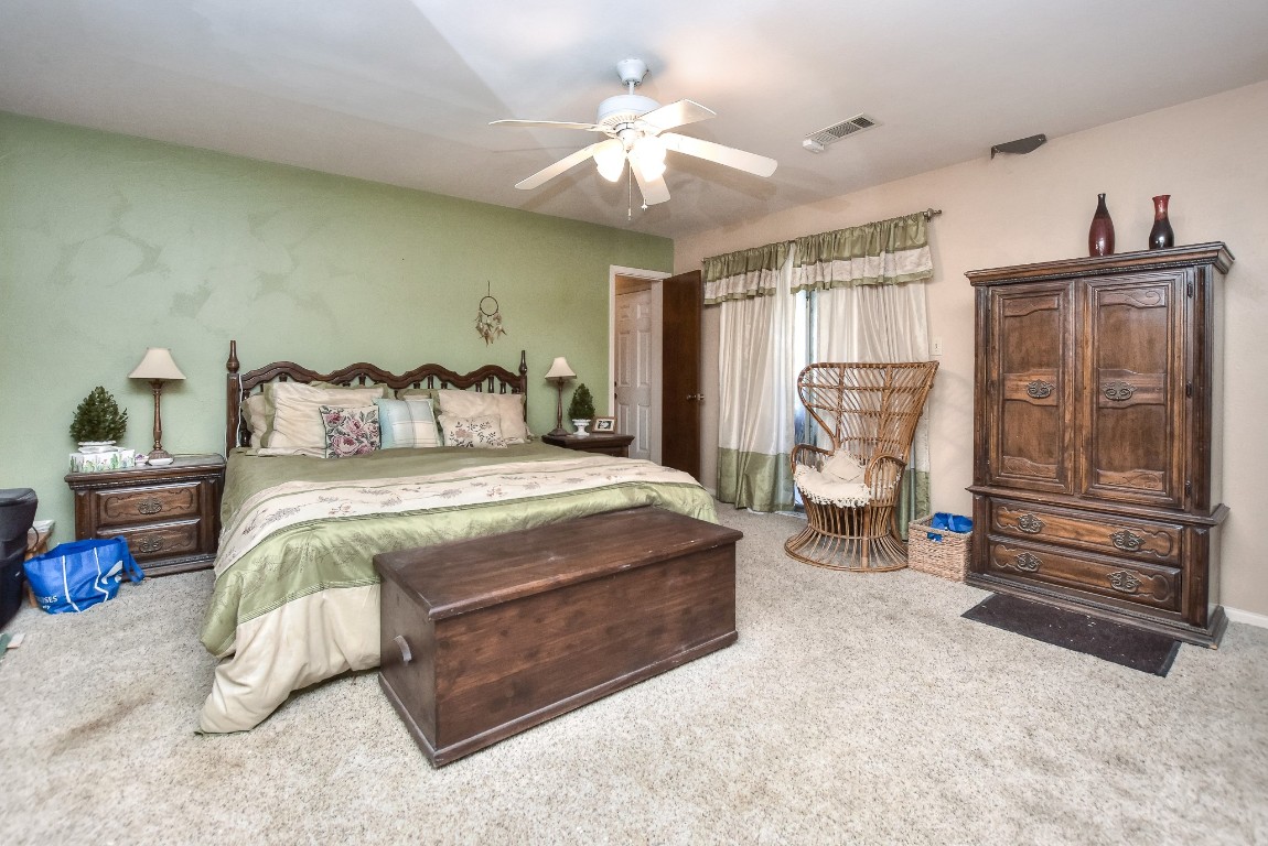 118 Oak Ridge Circle Georgetown, TX 78628 - Photo 16 of 40 a bed room with a bed and a chandelier