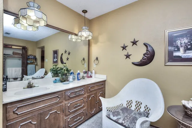 a bathroom with a double vanity sink and a mirror