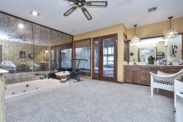 a view of a livingroom with furniture and a to ceiling window
