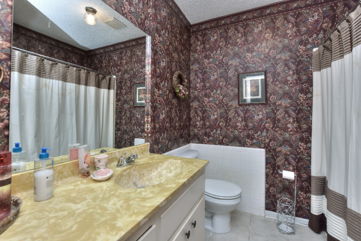 118 Oak Ridge Circle Georgetown, TX 78628 - Photo 29 of 40 a bathroom with a granite countertop sink and a mirror