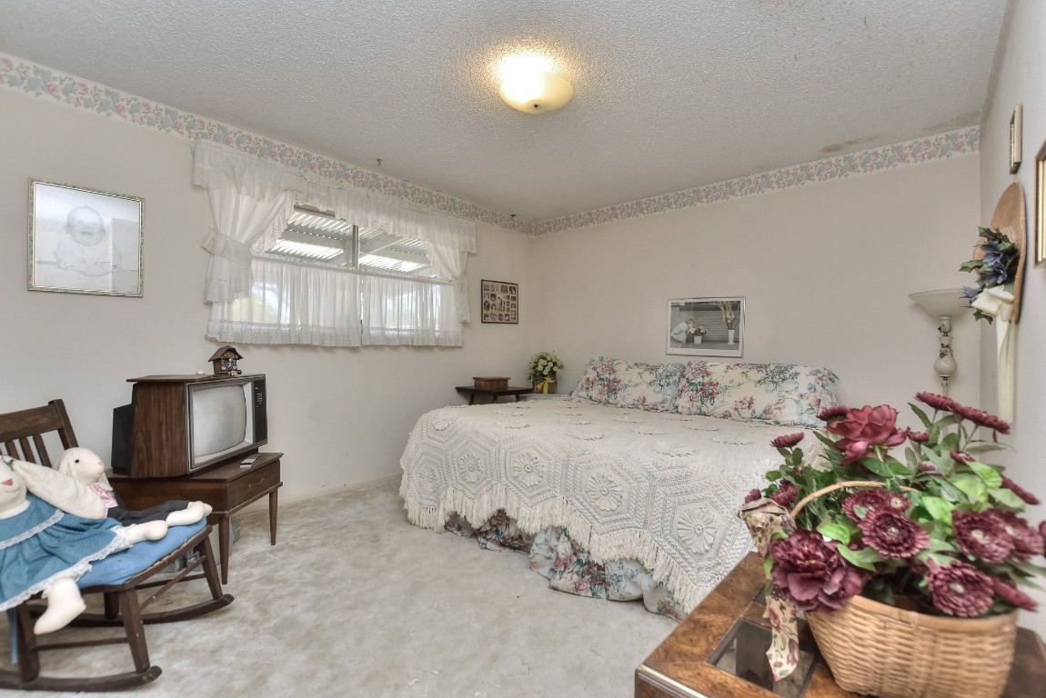 118 Oak Ridge Circle Georgetown, TX 78628 - Photo 31 of 40 a bedroom with a bed potted plant on dresser and a window