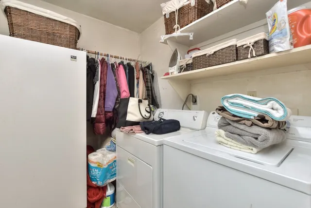 a view of walk in closet with clothes and shoes