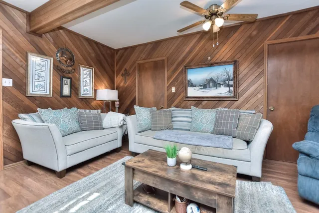 a living room with furniture and wooden floor