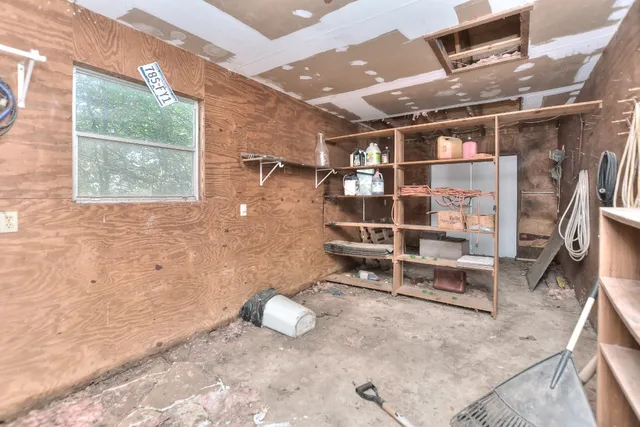 a view of an empty room with a wooden floor and a window