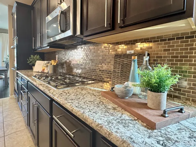a kitchen with a stove a sink and a microwave