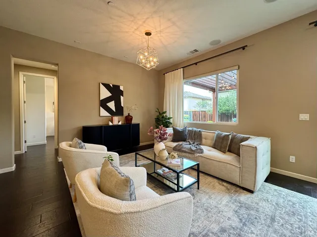 a living room with furniture and floor to ceiling windows