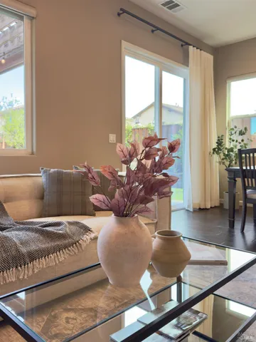a living room with lots of furniture and kitchen view