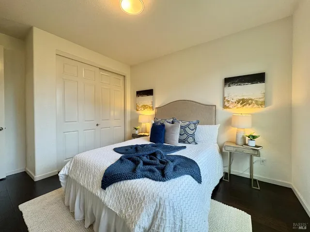 a bathroom with a double vanity sink toilet mirror and shower