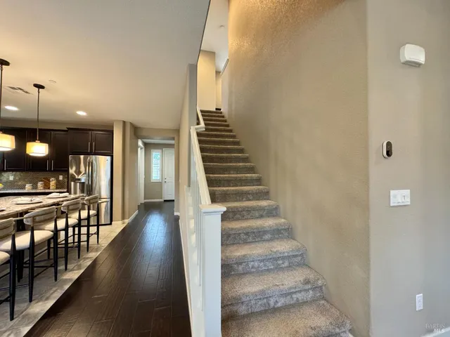 a bathroom with a double vanity sink toilet mirror and shower