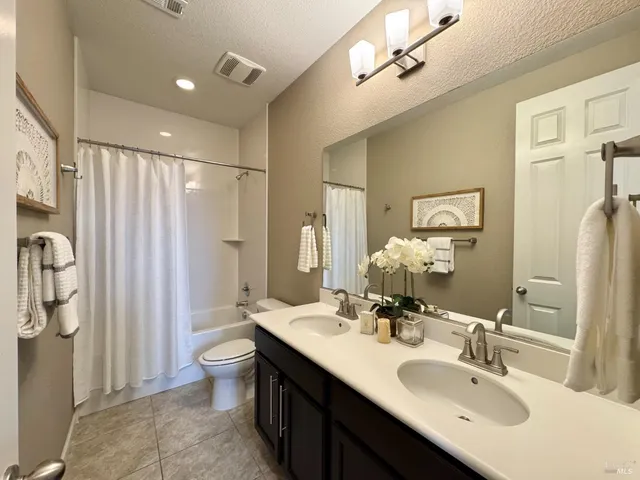 a bedroom with a bed and a painting on the wall