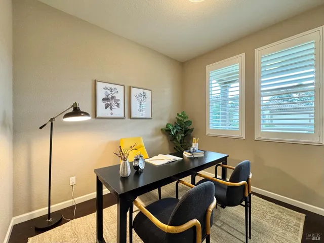 a kitchen with kitchen island granite countertop a table chairs sink and stove