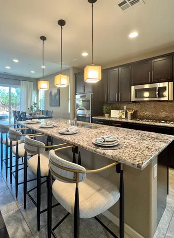 a kitchen with a table and a chandelier