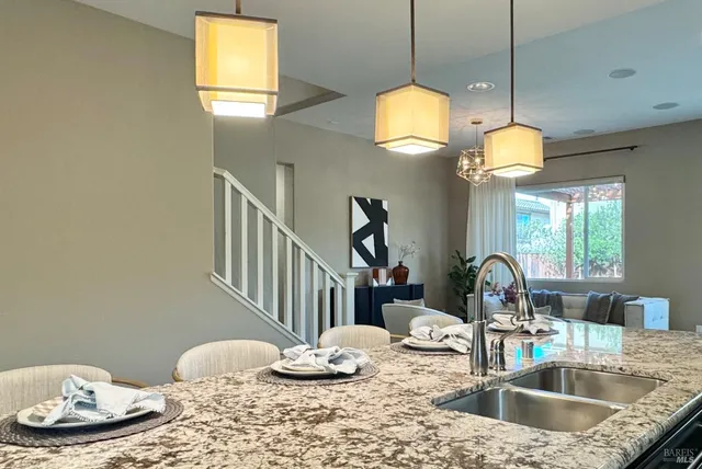 a large kitchen with kitchen island granite countertop a large center island and a stove