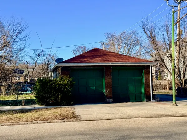 a view of a house with a small yard and potted plants