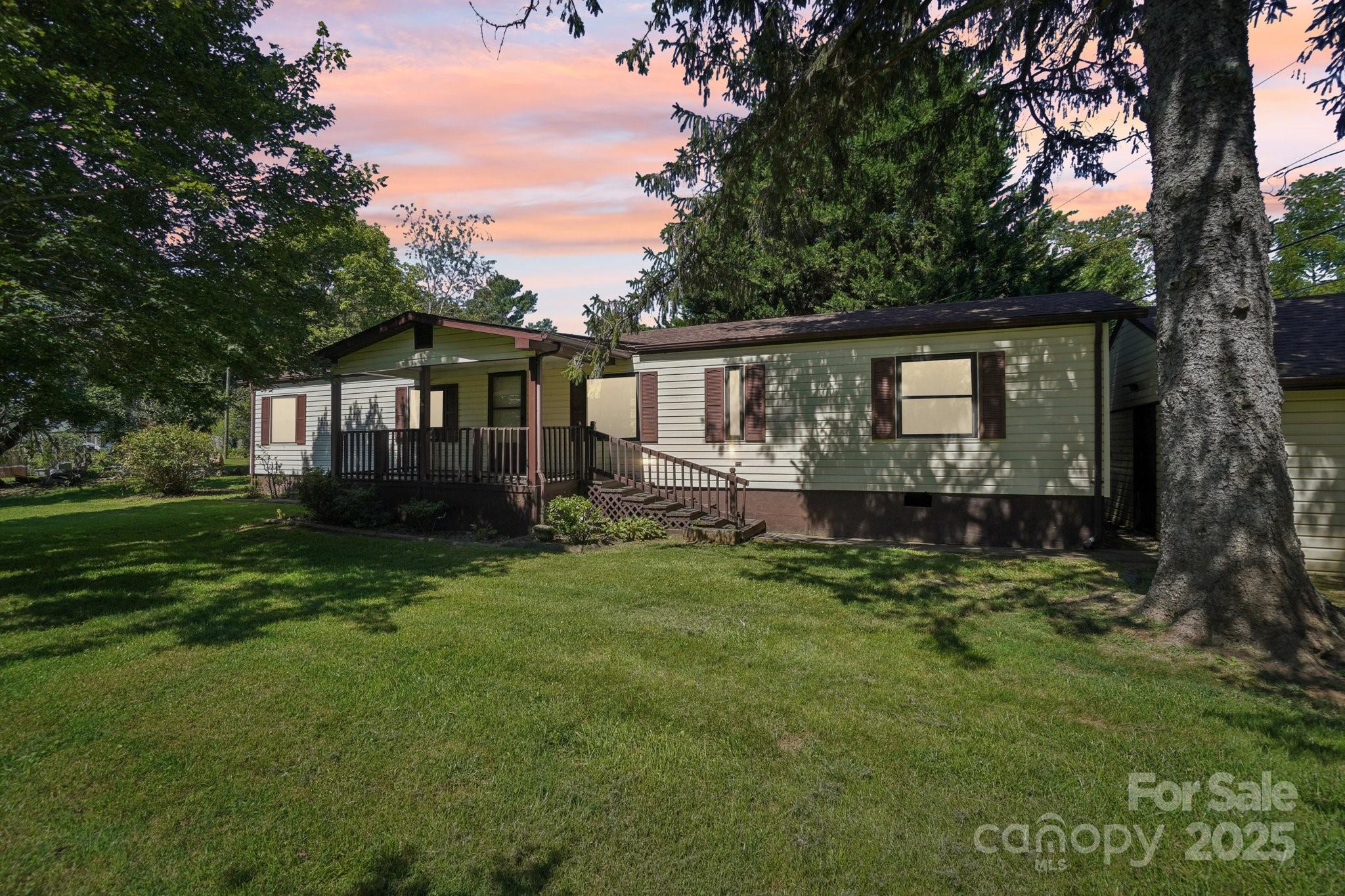 a view of a house with a backyard and garden