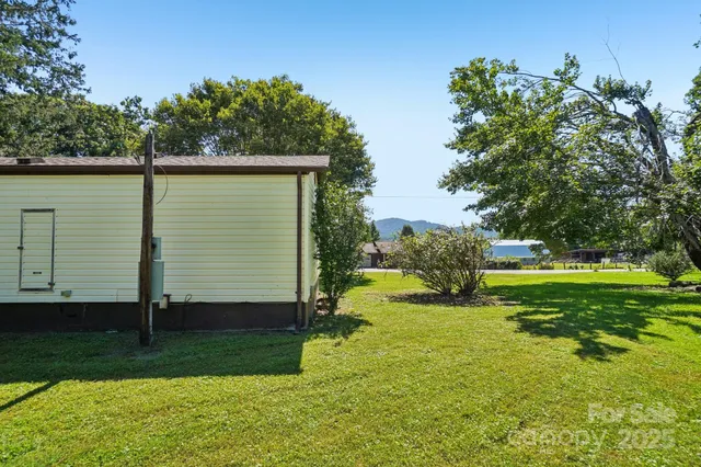 an aerial view of green landscape with houses