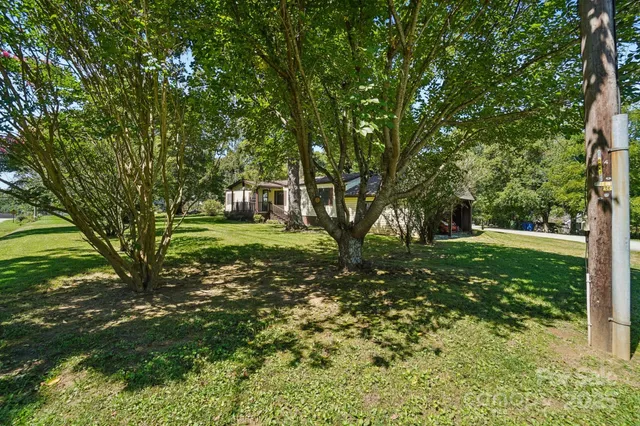 a big yard with lots of green space and trees