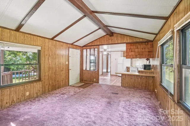 a large room with a large window and furniture