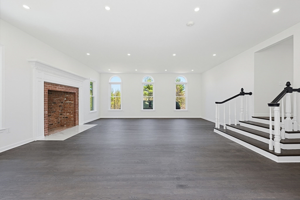 175 Pleasant Street Upton, MA 01568 - Photo 17 of 39 an empty room with windows and pillars in it
