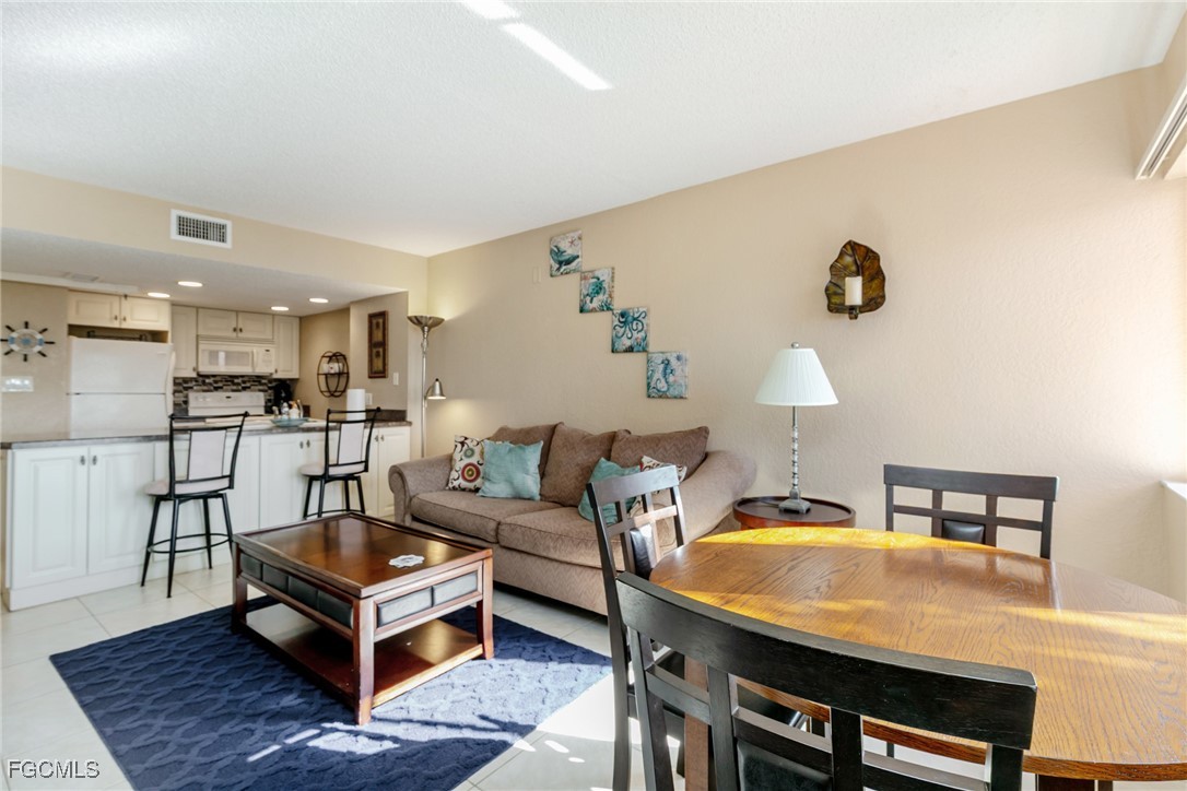 3170 Matecumbe Key Road, Unit 127 Punta Gorda, FL 33955 - Photo 7 of 26 a living room with furniture and a table