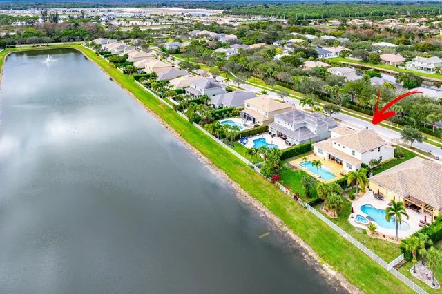 a front view of a house with swimming pool having outdoor seating