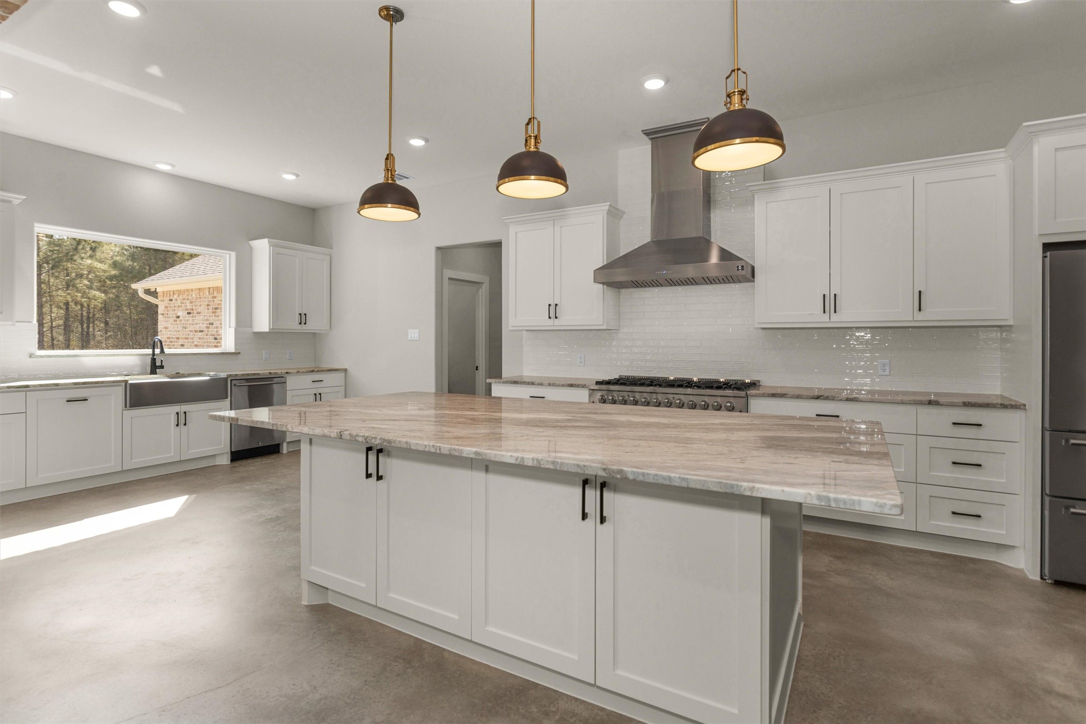 12744 Oak Barrel Road Willis, TX 77378 - Photo 13 of 50 The kitchen showcases an impressive oversized granite island that serves as both a stunning focal point and a functional gathering space. With ample room for seating, meal prep, and entertaining, this expansive island is perfect for hosting family and friends while staying connected to the heart of the home.