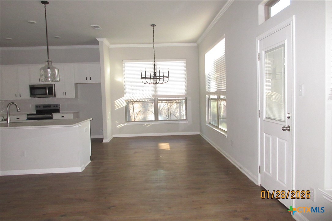 7311 Birdsnest Way Temple, TX 76502 - Photo 12 of 25 a view of an empty room with kitchen and a window