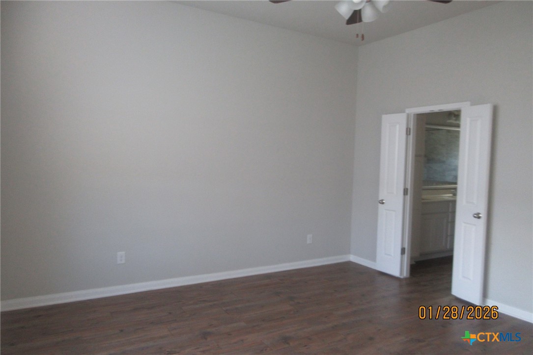 7311 Birdsnest Way Temple, TX 76502 - Photo 21 of 25 a view of an empty room with wooden floor and a ceiling fan