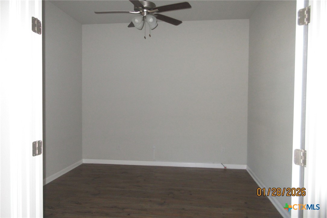 7311 Birdsnest Way Temple, TX 76502 - Photo 3 of 25 a view of an empty room with wooden floor and a window