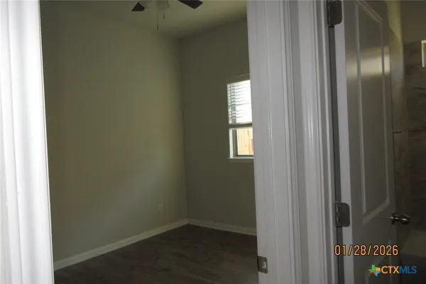 an empty room with wooden floor