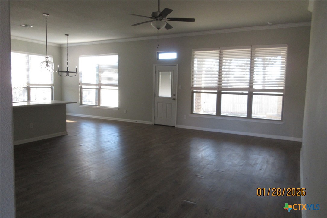 7311 Birdsnest Way Temple, TX 76502 - Photo 10 of 25 a view of an empty room with wooden floor and a window