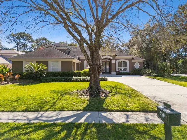 a view of a dining room and livingroom with furniture wooden floor a chandelier and a rug