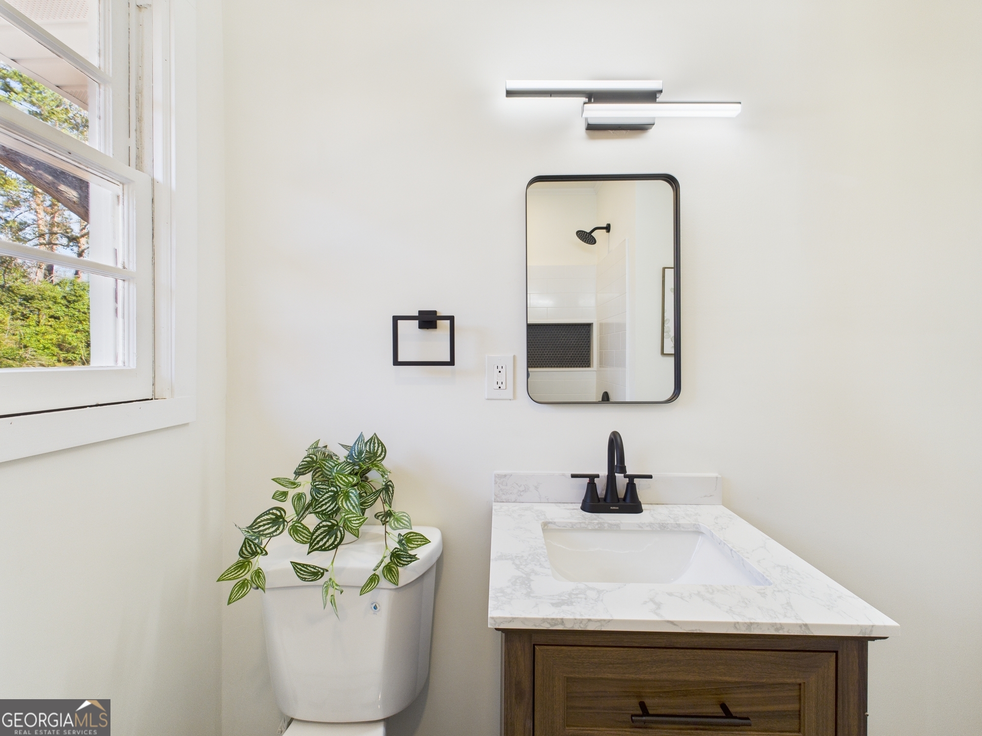 2489 Locksley Drive Macon, GA 31206 - Photo 22 of 42 a bathroom with a sink mirror and vanity