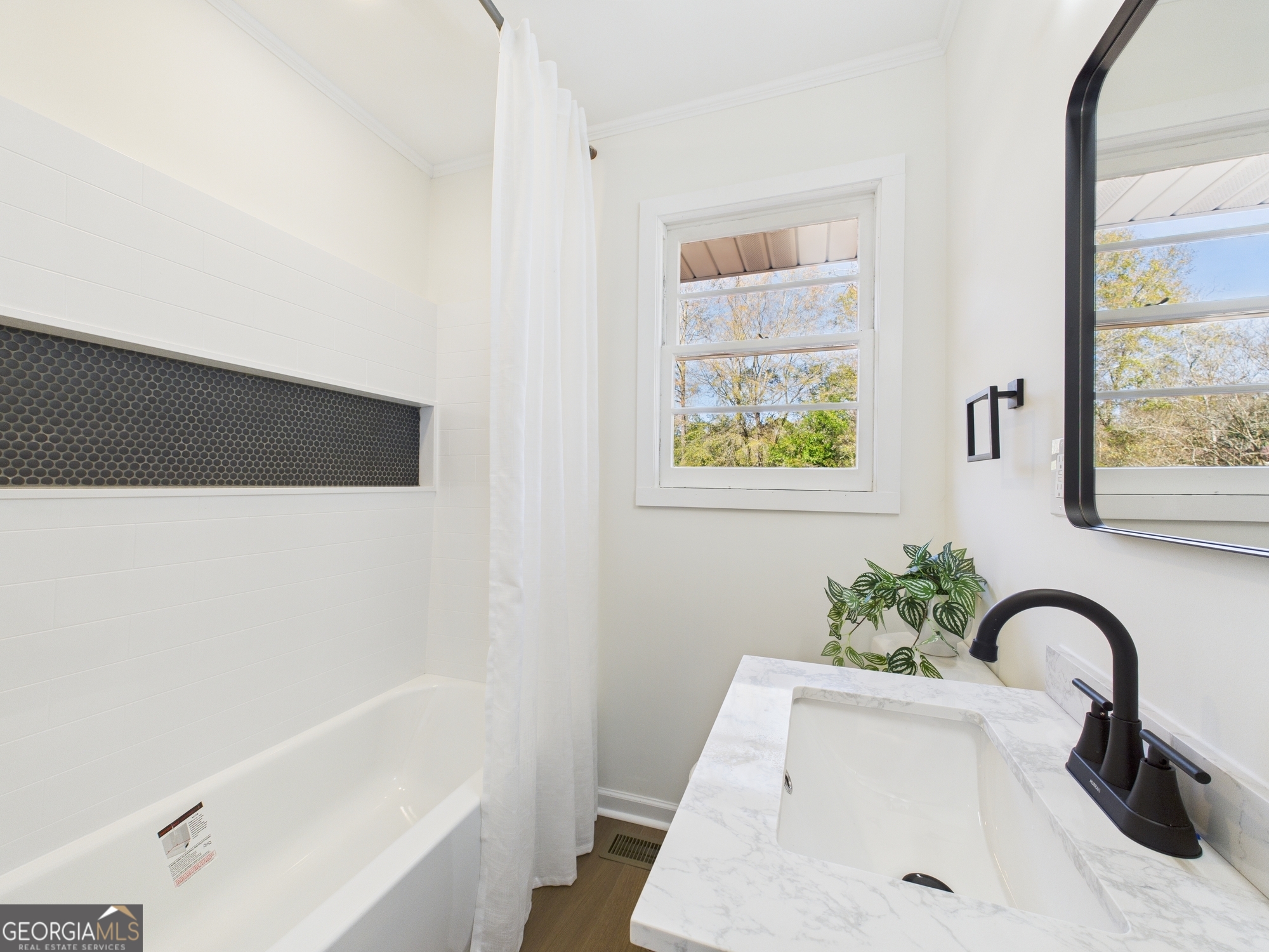 2489 Locksley Drive Macon, GA 31206 - Photo 23 of 42 a bathroom with a sink and a bathtub
