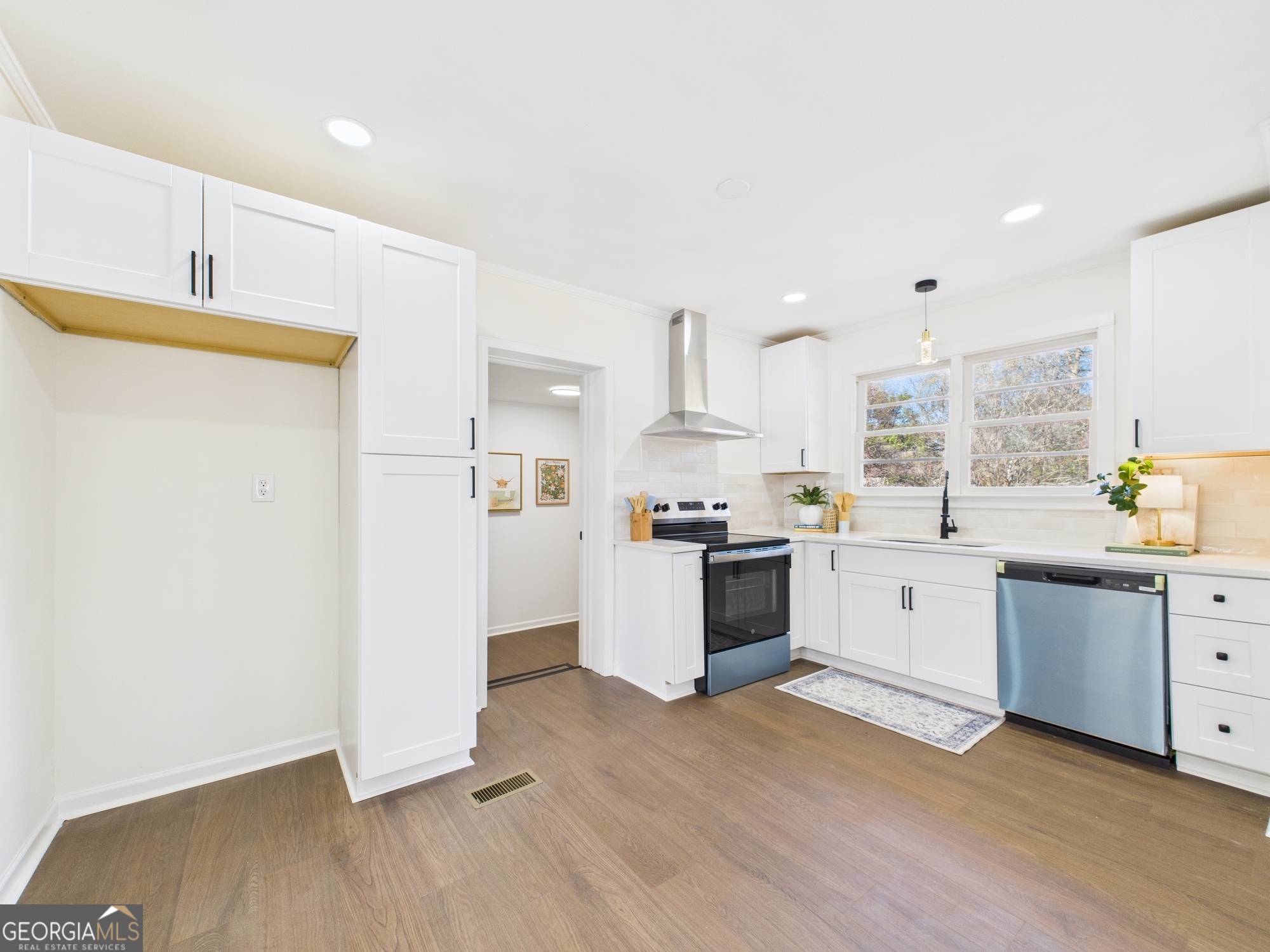2489 Locksley Drive Macon, GA 31206 - Photo 9 of 42 a kitchen with white cabinets and white appliances