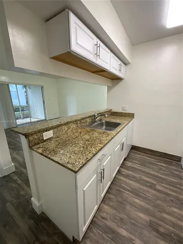 a kitchen with sink and stove