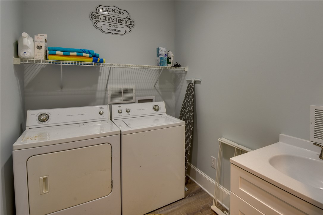206 Petty Road Seneca, SC 29672 - Photo 34 of 48 Functional laundry room equipped with essential appliances and convenient shelving.