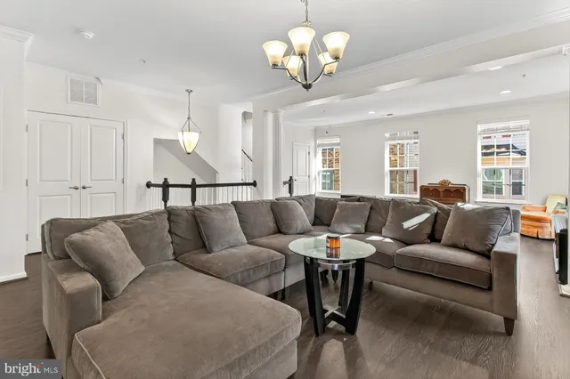 a living room with furniture chandelier and a chandelier