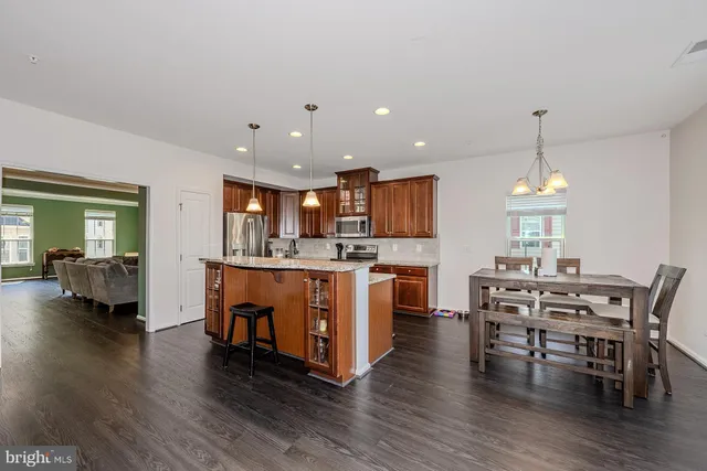 a view of kitchen with table and chairs