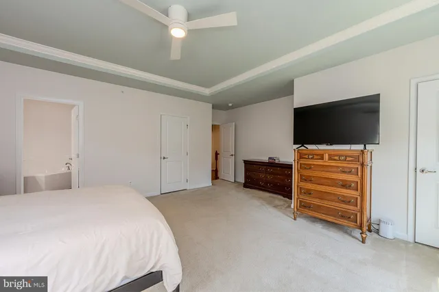 a bedroom with a bed and flat screen tv