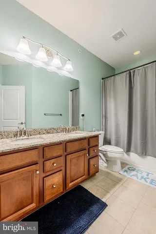 a bathroom with double vanity sink and a mirror