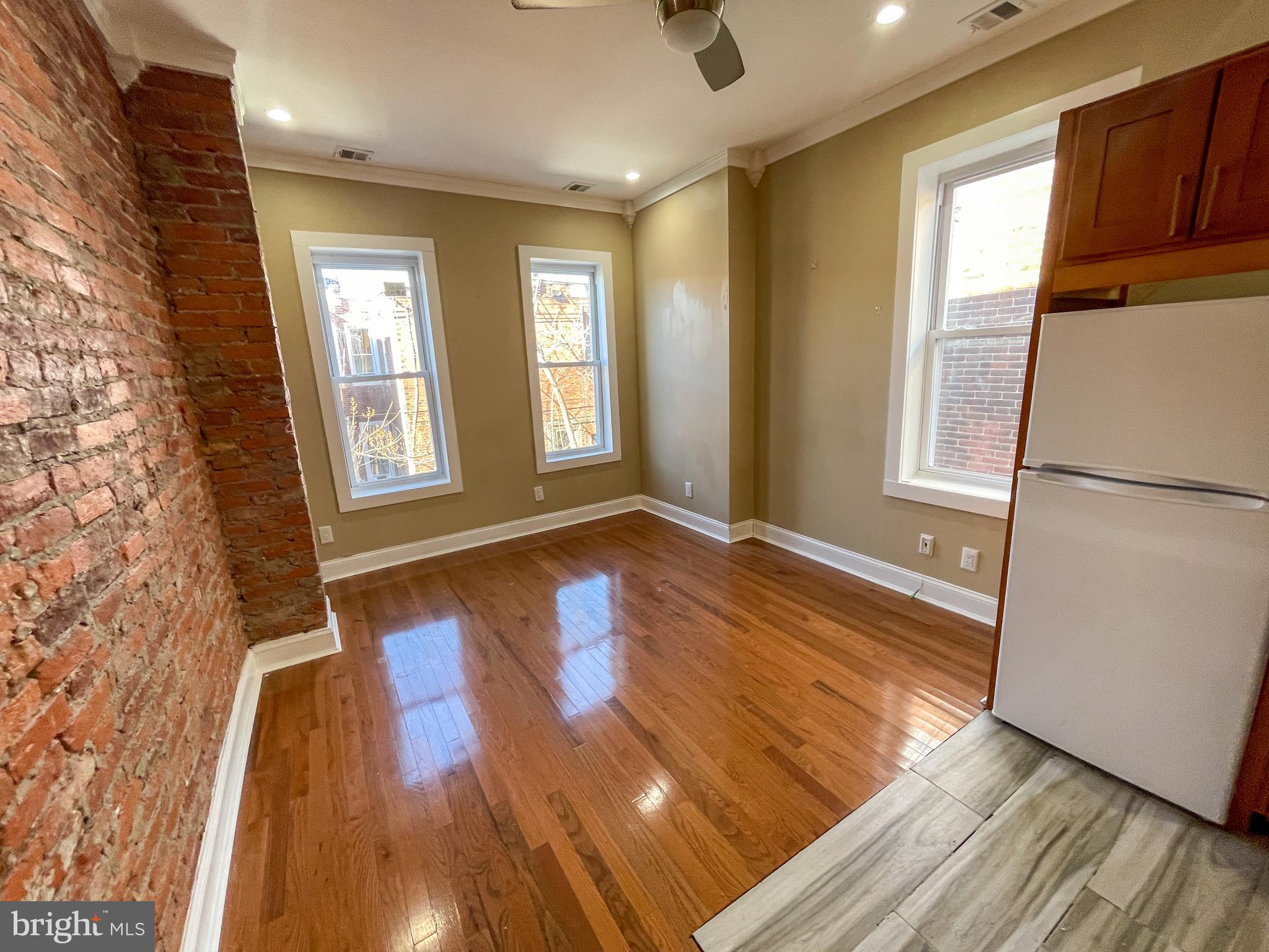 122 North 53rd Street Philadelphia, PA 19139 - Photo 3 of 11 a view of empty room with wooden floor and fan