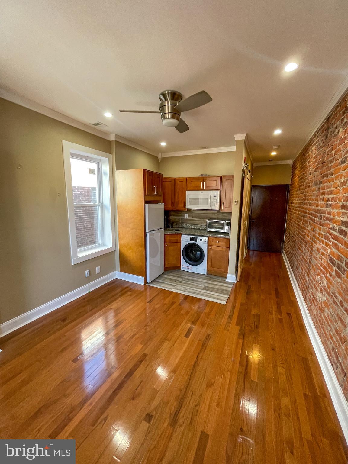 122 North 53rd Street Philadelphia, PA 19139 - Photo 4 of 11 a view of a kitchen with a sink and a microwave